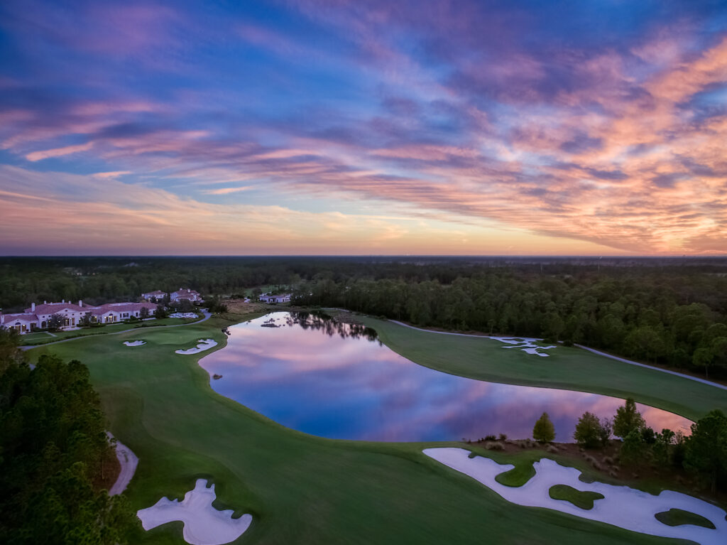 Hole 18 10 and clubhouse Aerial sunset